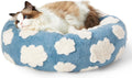 Cat lying on a blue and white cloud-patterned pet bed
