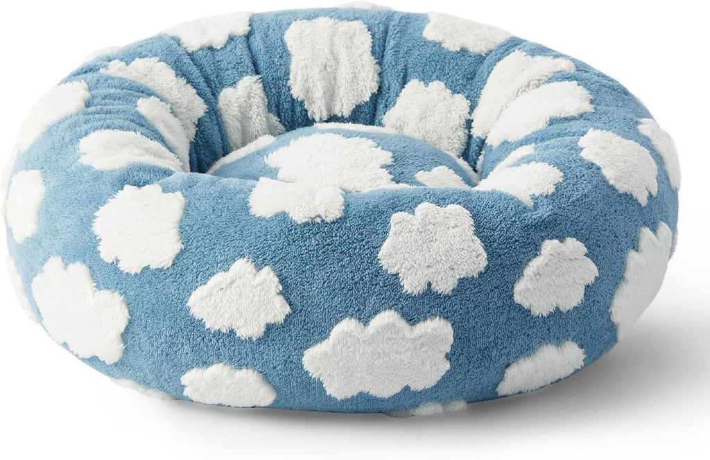 Dog relaxing in a MIAYLUNE donut dog bed with a soft blue cloud pattern.