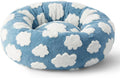 Dog relaxing in a MIAYLUNE donut dog bed with a soft blue cloud pattern.