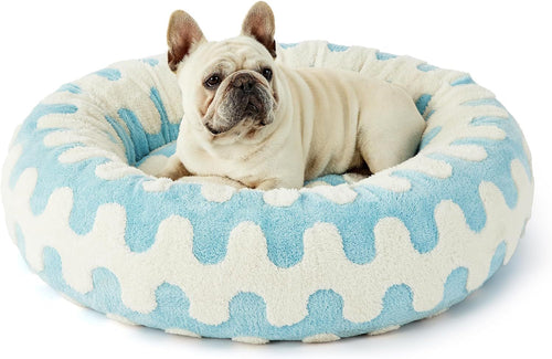 Dog sitting comfortably in a MIAYLUNE donut dog bed featuring a blue wave pattern.
